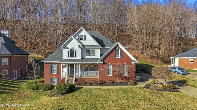 front facade with a porch and a front yard