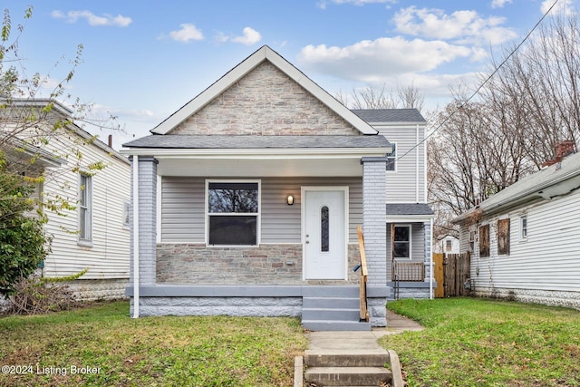 view of front of property featuring a porch and a front lawn