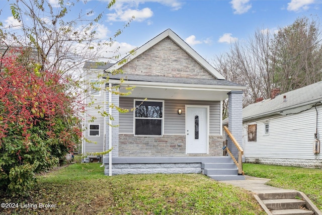 bungalow featuring a front lawn and covered porch