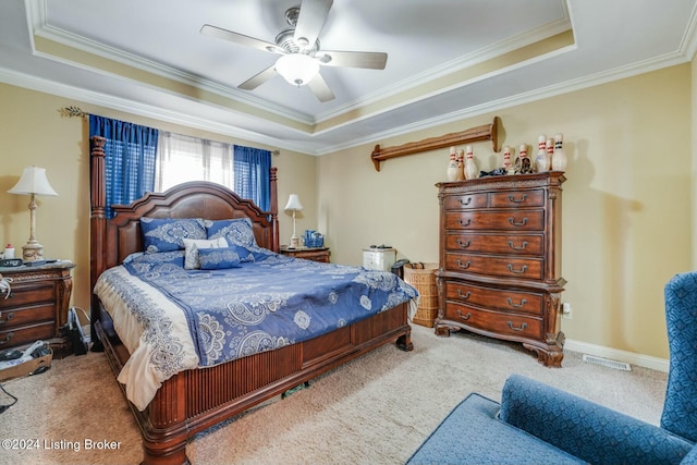 bedroom with a raised ceiling, ceiling fan, and crown molding