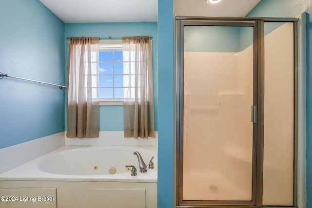 bathroom featuring separate shower and tub