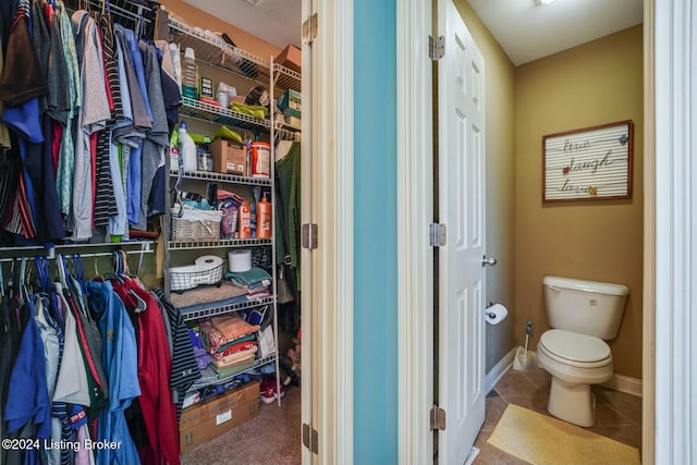 bathroom with tile patterned flooring and toilet