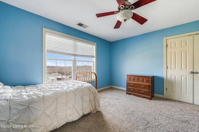 bedroom with ceiling fan, a closet, and carpet floors