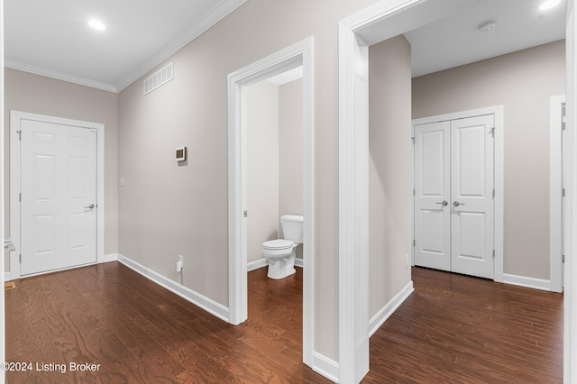 corridor featuring dark hardwood / wood-style flooring and ornamental molding