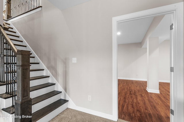 staircase featuring hardwood / wood-style floors