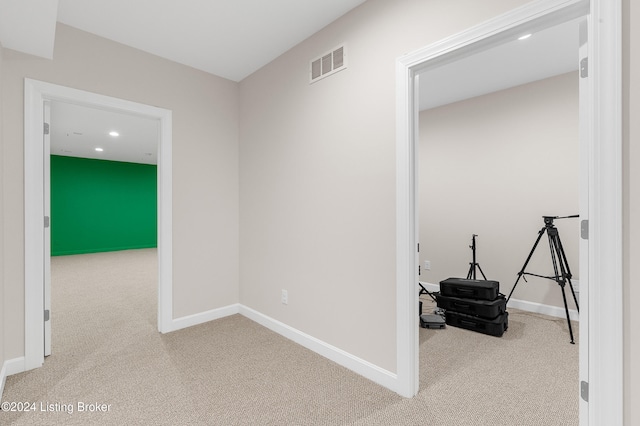 hallway with light colored carpet