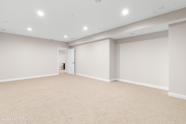 basement featuring light colored carpet