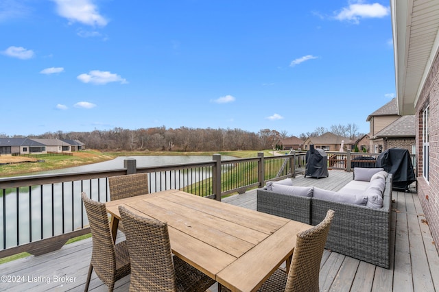 deck featuring an outdoor living space, a water view, and area for grilling