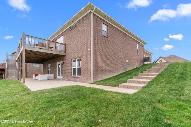 rear view of house featuring a patio area, a yard, and a wooden deck