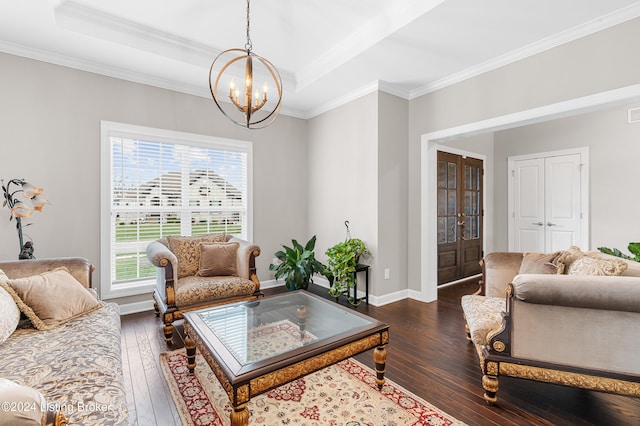 living room featuring a notable chandelier, dark hardwood / wood-style flooring, crown molding, and french doors