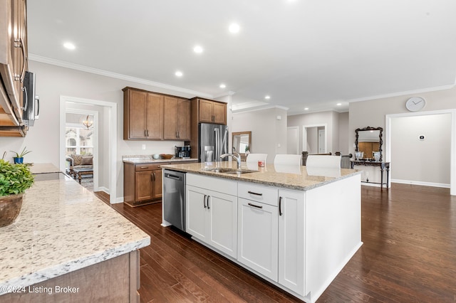 kitchen with dark wood-type flooring, sink, light stone countertops, white cabinetry, and stainless steel appliances