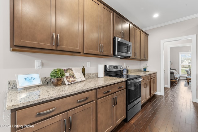 kitchen featuring light stone countertops, dark hardwood / wood-style flooring, stainless steel appliances, and crown molding