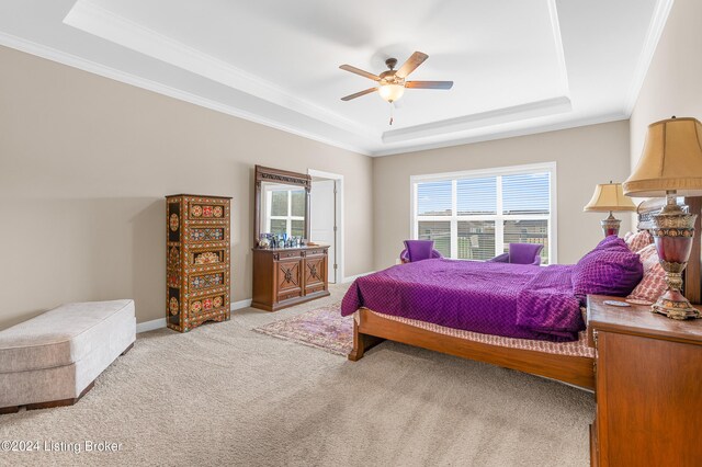 bedroom with light carpet, a raised ceiling, ceiling fan, and ornamental molding