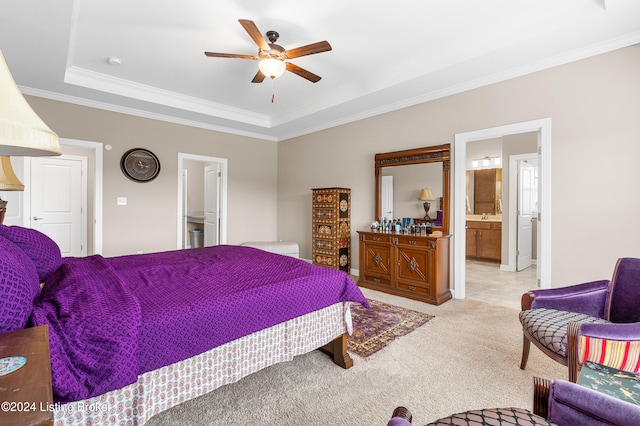 carpeted bedroom with ceiling fan, crown molding, connected bathroom, and a tray ceiling