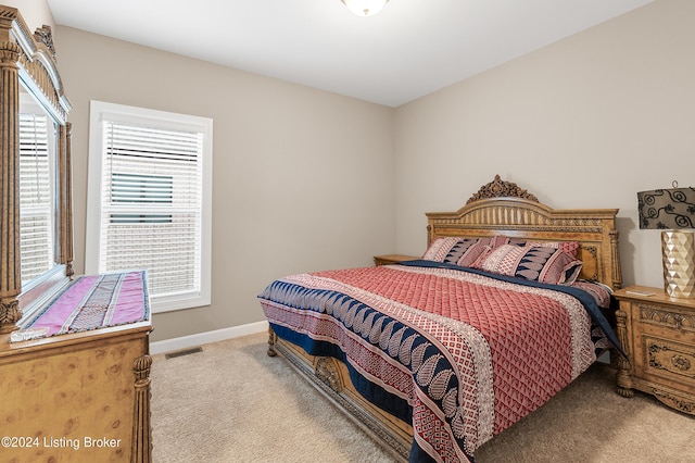 carpeted bedroom featuring multiple windows