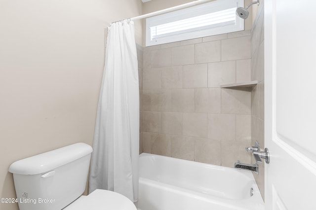 bathroom with toilet and shower / tub combo with curtain