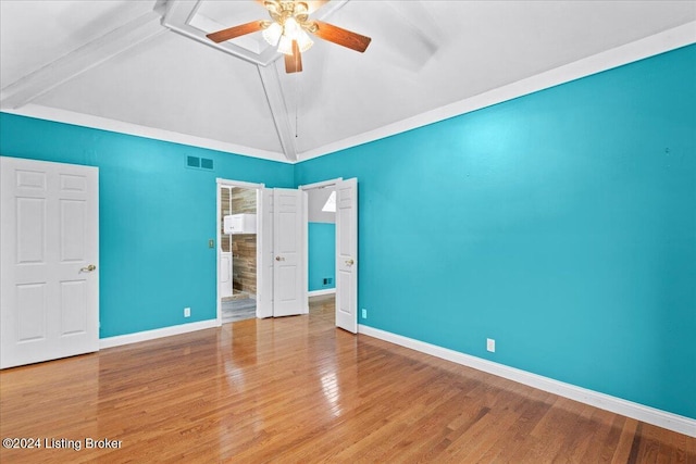 unfurnished bedroom with vaulted ceiling with beams, baseboards, visible vents, and wood finished floors