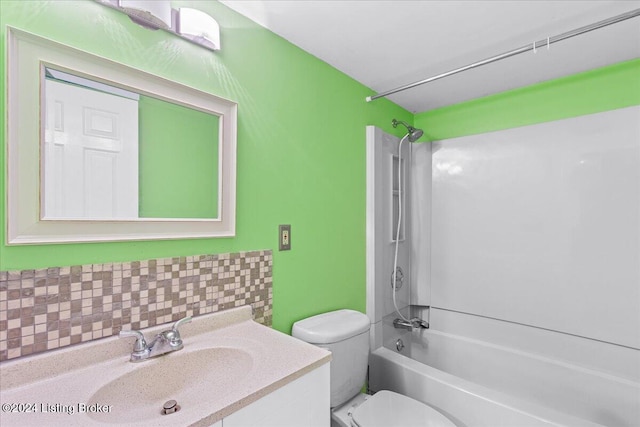 bathroom with vanity, backsplash, shower / tub combination, and toilet