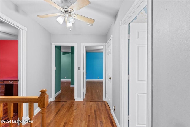 hall featuring baseboards and wood finished floors