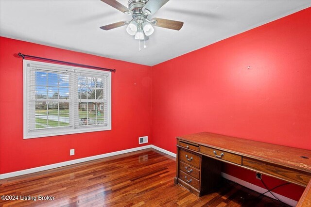 office space with baseboards, visible vents, dark wood finished floors, and a ceiling fan