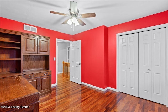 interior space featuring visible vents, baseboards, and wood finished floors