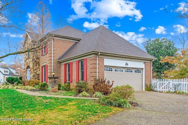 view of front of property with a front yard and a garage