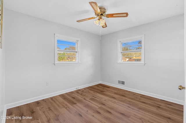 unfurnished room with wood-type flooring, plenty of natural light, and ceiling fan