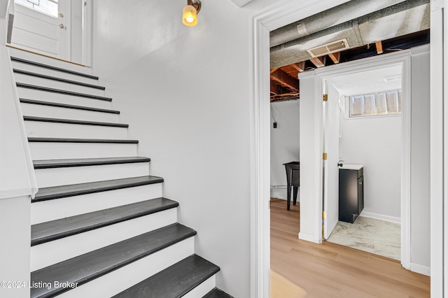 stairway with hardwood / wood-style floors