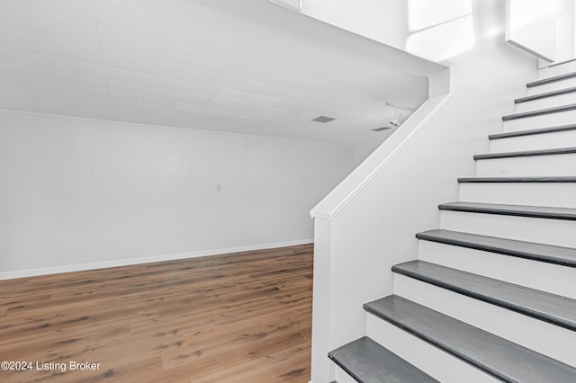 staircase featuring hardwood / wood-style flooring