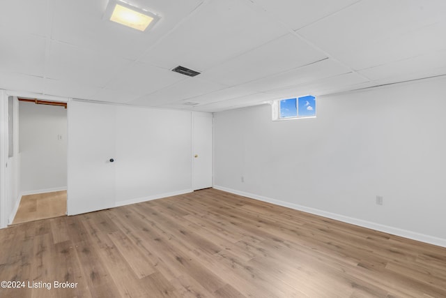 basement with light hardwood / wood-style floors