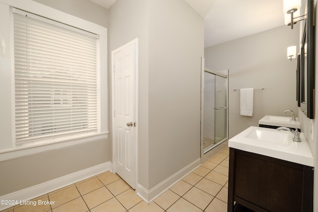 bathroom featuring tile patterned flooring, vanity, and walk in shower