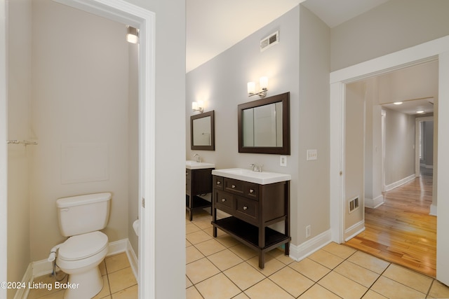 bathroom with vanity, wood-type flooring, and toilet