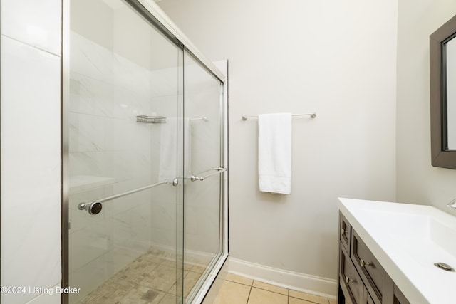 bathroom with tile patterned floors, vanity, and a shower with shower door