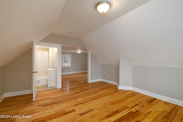 bonus room featuring light hardwood / wood-style floors and vaulted ceiling