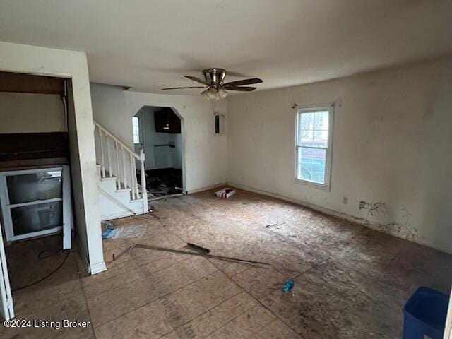 unfurnished living room featuring ceiling fan