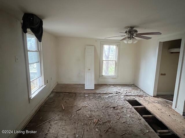 interior space with ceiling fan