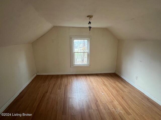 bonus room featuring light hardwood / wood-style flooring and lofted ceiling