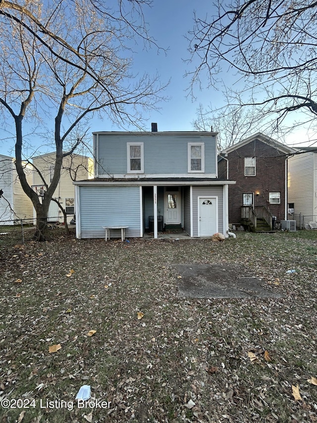 rear view of property with central AC unit