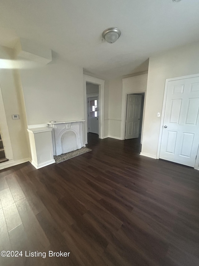 unfurnished living room featuring dark hardwood / wood-style flooring