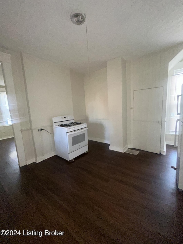 kitchen with white cabinets, white gas stove, dark hardwood / wood-style flooring, and a textured ceiling