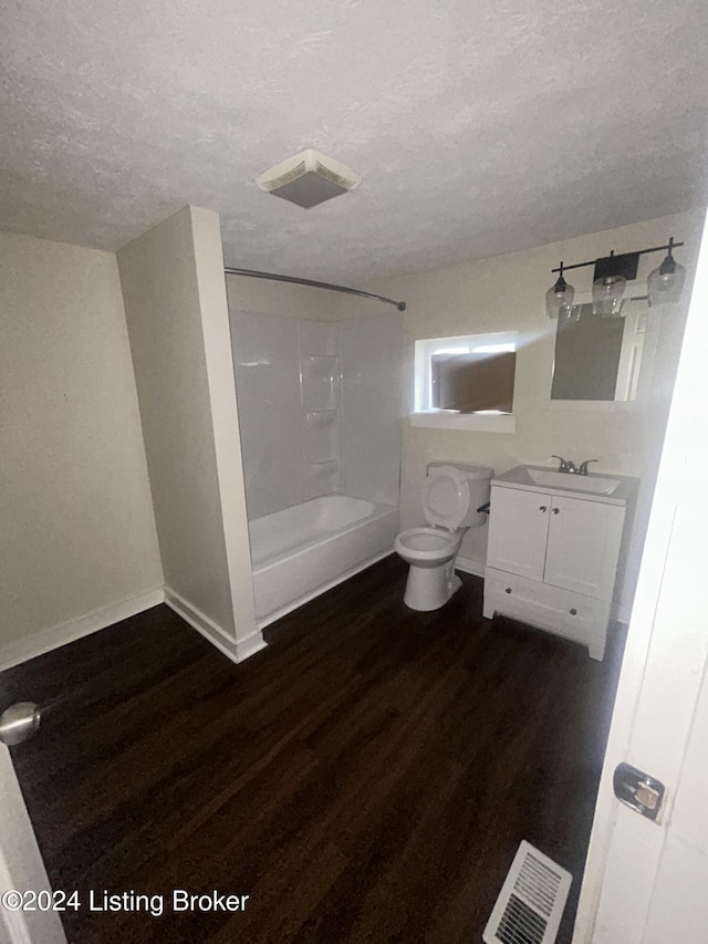 full bathroom featuring shower / bath combination, vanity, a textured ceiling, hardwood / wood-style flooring, and toilet