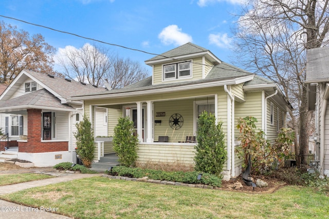 bungalow-style home featuring a front yard