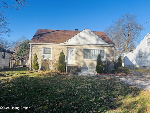 bungalow-style home with a front yard