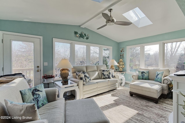 sunroom / solarium with ceiling fan and lofted ceiling with skylight