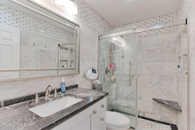 bathroom featuring backsplash, an enclosed shower, vanity, tile walls, and toilet