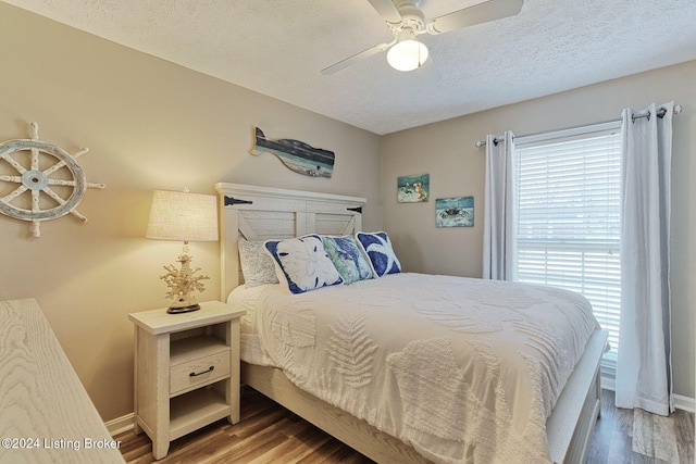 bedroom featuring hardwood / wood-style flooring, ceiling fan, and a textured ceiling