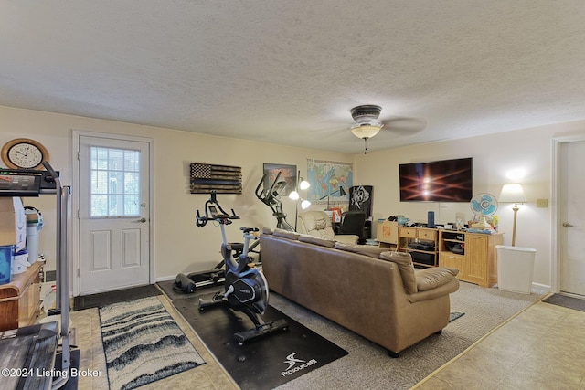 living room featuring a textured ceiling and ceiling fan