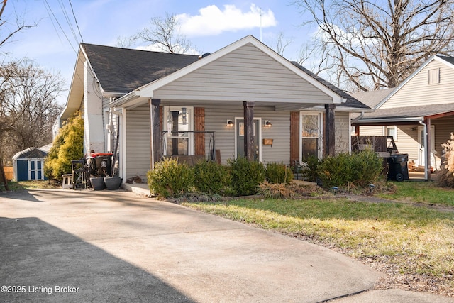 bungalow-style home with a front yard and covered porch