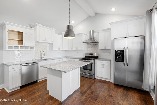 kitchen featuring stainless steel appliances, white cabinetry, decorative light fixtures, and wall chimney exhaust hood