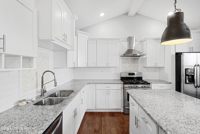 kitchen with pendant lighting, sink, white cabinetry, stainless steel appliances, and wall chimney exhaust hood